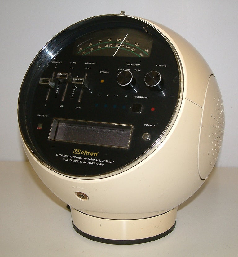 This futuristic Weltron Model 2001 8 track stereo AM-FM radio has a AC/DC power supply and a rubber suction non slip base.  The white plastic housing is in very good condition.  The radio is in working order however the 8 track tape player needs a